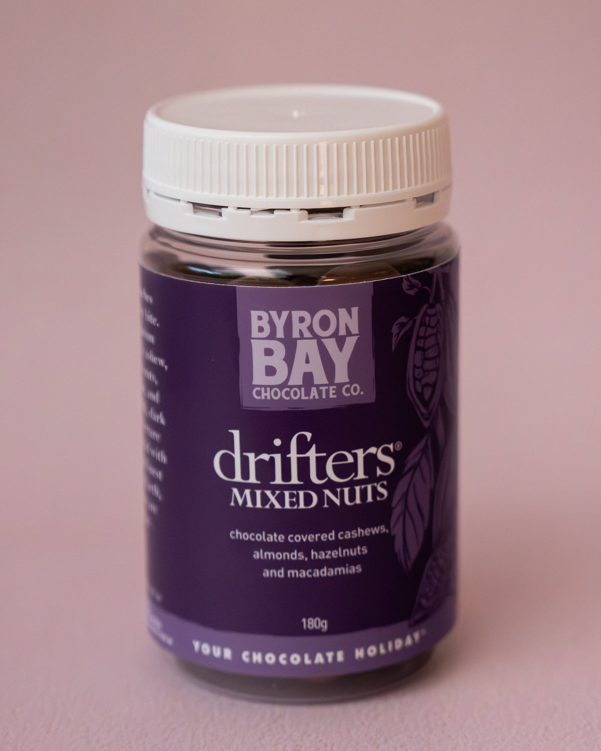 Jar of Byron Bay Chocolates Drifters Mixed Nuts on a pink background