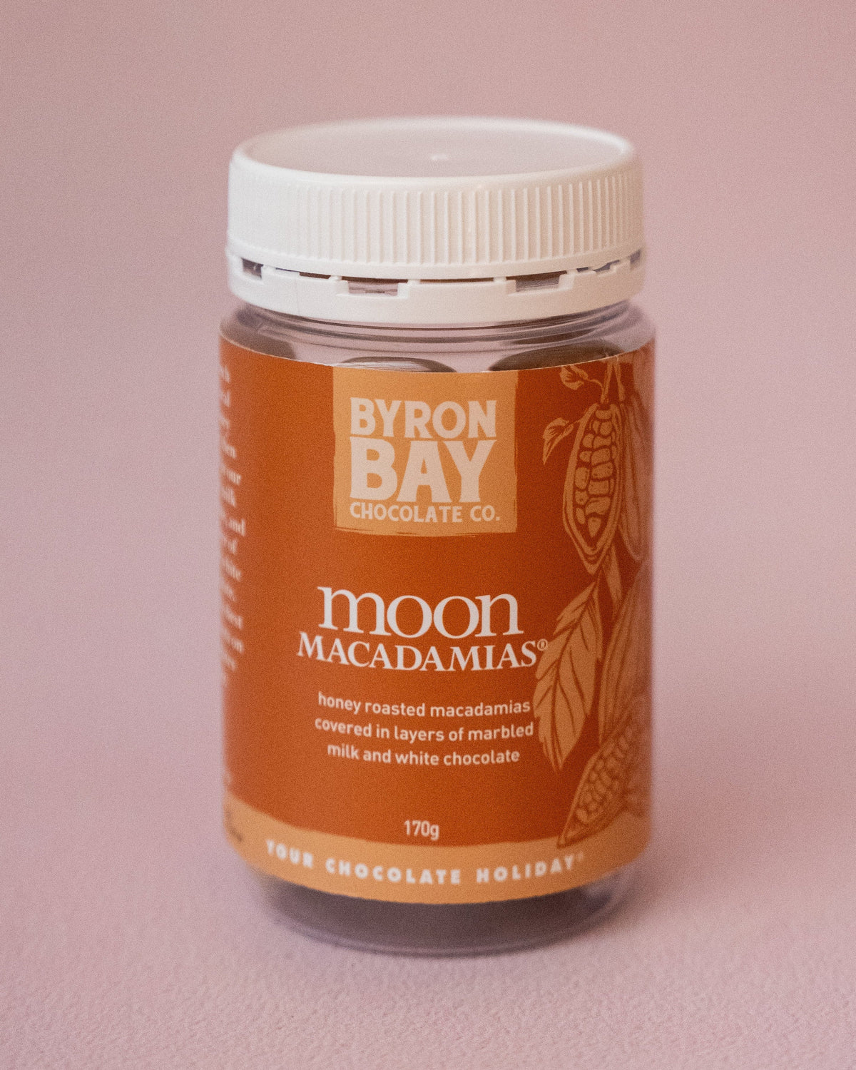 Jar of Byron Bay Macadamias on a pink background